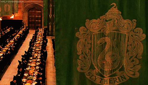 A Slytherin Banner Hangs In Front Of A Long Dining Room GIF