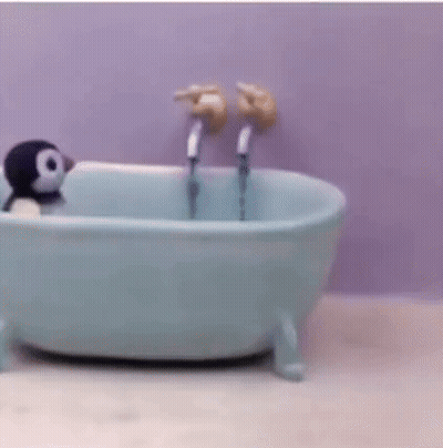 A Small Bathtub With Two Faucets And A Person In It . GIF