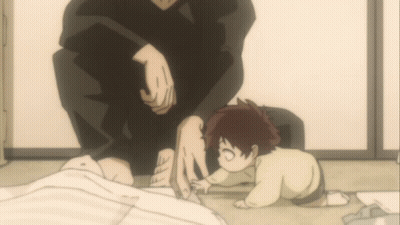 A Small Child Is Crawling On The Floor Next To A Man GIF