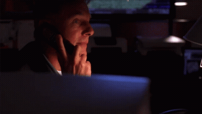 A Smiling Man Is Talking On A Cell Phone GIF