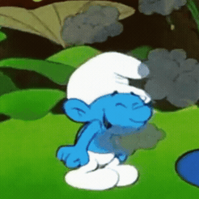 A Smurf Is Standing In The Grass With His Eyes Closed And Smiling GIF