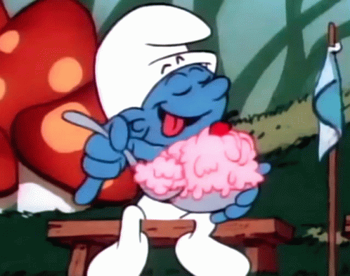 A Smurf Sitting On A Bench Eating Ice Cream With A Cherry On Top GIF