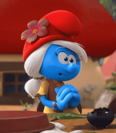 A Smurf Wearing A Red Hat And A Yellow Shirt GIF