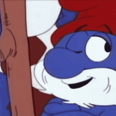 A Smurf With A Red Hat And Beard Is Holding A Wooden Stick . GIF