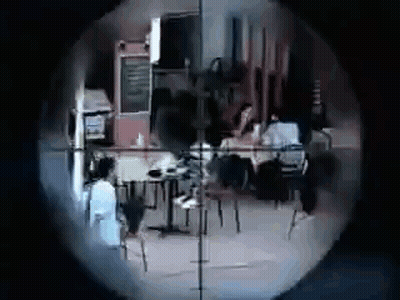 A Sniper 'S Scope Shows A Group Of People Sitting At Tables In A Restaurant . GIF