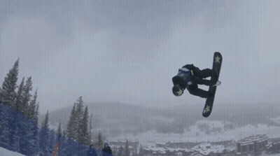 A Snowboarder Is Doing A Trick In The Air While Wearing A Blue And Yellow Shirt That Says ' A ' On It GIF