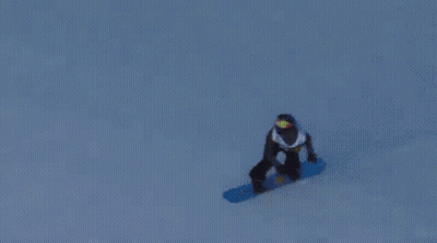 A Snowboarder Is Doing A Trick On A Snowy Slope GIF