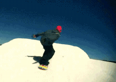 A Snowboarder Is Doing A Trick On Top Of A Snow Covered Hill GIF
