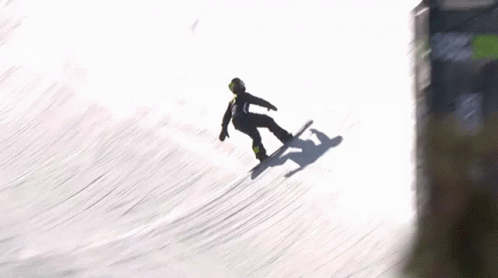 A Snowboarder Is Falling Off A Ramp In The Snow GIF