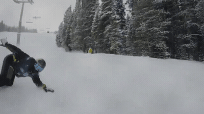 A Snowboarder Wearing A Blue Shirt With The Number 17 On It Is Going Down A Snow Covered Slope GIF