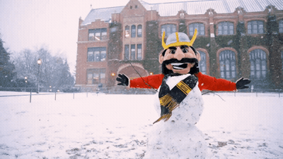 A Snowman Wearing A Viking Costume Is Standing In The Snow GIF