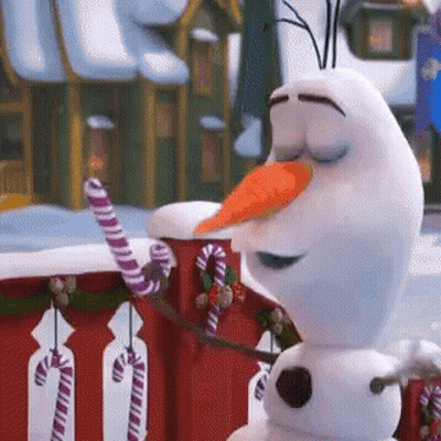 A Snowman With A Carrot In His Mouth Is Holding A Candy Cane . GIF