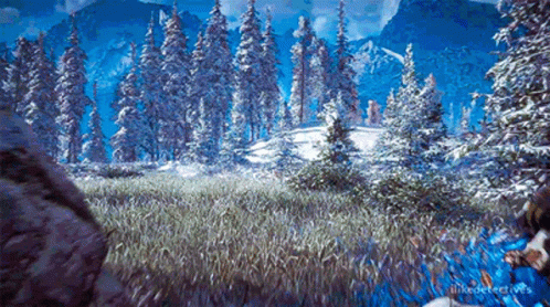 A Snowy Forest With Trees Covered In Snow And Mountains In The Background . GIF