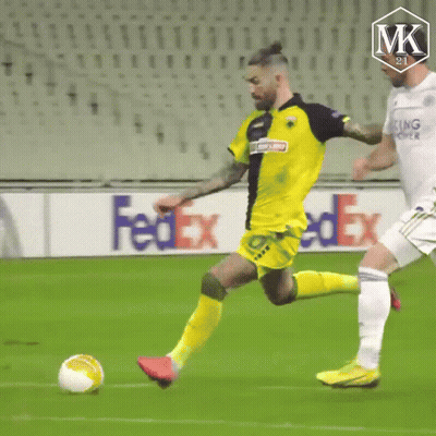 A Soccer Ball Is Being Kicked On A Field With A Fedex Ad In The Background . GIF