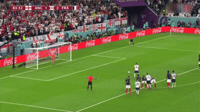 A Soccer Field With Coca Cola Advertisements On The Side GIF