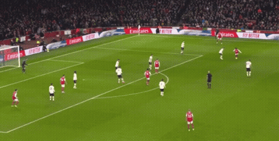 A Soccer Field With Emirates Advertisements On The Side GIF