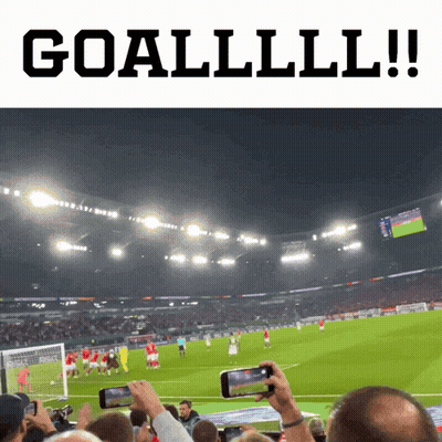 A Soccer Game Is Being Played In A Stadium And People Are Taking Pictures Of It GIF