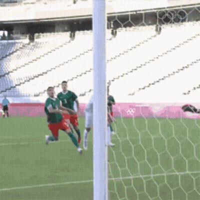A Soccer Game Is Being Played In A Stadium With The Olympics Logo In The Background GIF