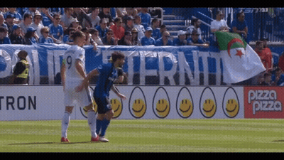 A Soccer Game Is Being Played In Front Of A Banner That Says Pizza Pizza GIF