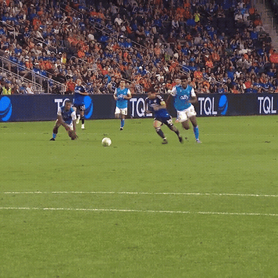 A Soccer Game Is Being Played In Front Of A Banner That Says Tol GIF