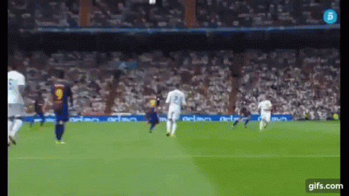 A Soccer Game Is Being Played In Front Of A Crowd GIF