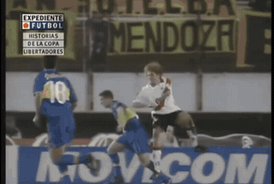A Soccer Game Is Being Played In Front Of A Mendoza Banner GIF
