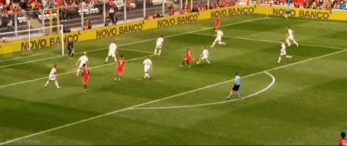 A Soccer Game Is Being Played On A Field With A Banner That Says Novo Banco GIF