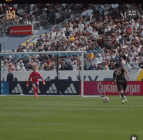 A Soccer Game Is Being Played On A Field With A Captain Morgan Ad In The Background GIF
