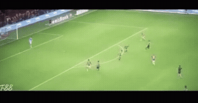 a soccer game is being played on a field with a lot of people on it .