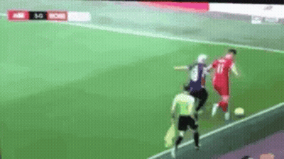 A Soccer Game Is Being Played On A Field With A Referee . GIF