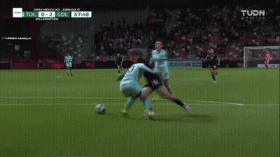 A Soccer Game Is Being Played On A Tv Screen That Says Tudn GIF