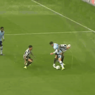 A Soccer Game Is Underway And A Goalie Is Diving To Catch A Ball GIF