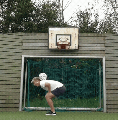 A Soccer Goal With A Basketball Hoop On The Wall Behind It GIF