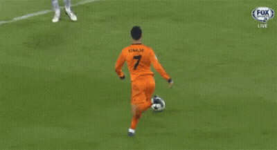 A Soccer Goalie Catches A Ball In Front Of A Heineken Advertisement GIF