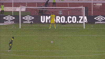 A Soccer Goalie Dives Into The Net During A Game With Sky Sports In The Background GIF