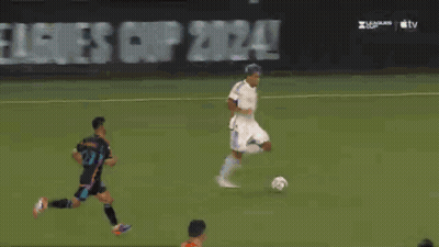 A Soccer Goalie Dives To Catch A Ball In Front Of An At & T Advertisement GIF