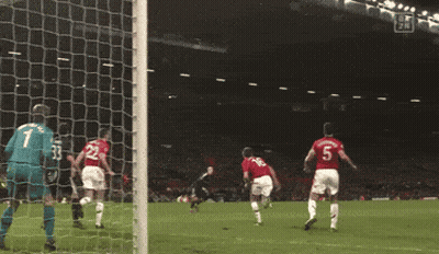 A Soccer Goalie Is Diving To Catch A Ball During A Game GIF