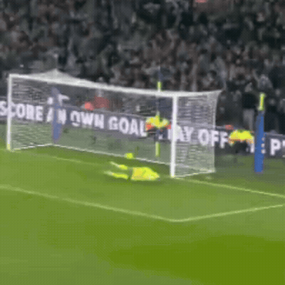 A Soccer Goalie Is Diving To Catch A Ball In Front Of A Sign That Says Score An Own Goal GIF
