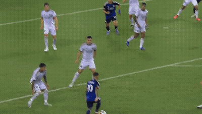A Soccer Goalie Is Diving To Catch A Ball In Front Of An Adidas Sign GIF