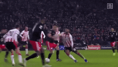 A Soccer Goalie Is Diving To Catch A Soccer Ball During A Game GIF
