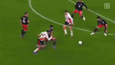 A Soccer Goalie Is Diving To Catch The Ball In Front Of A Heineken Ad GIF