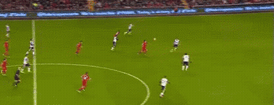 A Soccer Goalie Is Jumping In The Air To Catch A Soccer Ball In A Stadium . GIF