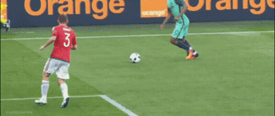 A Soccer Goalie Jumps To Catch A Soccer Ball In Front Of A Net That Says Iconic James GIF