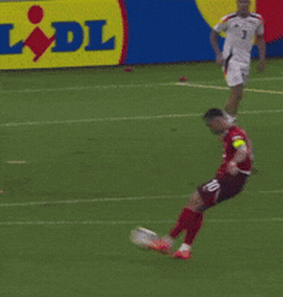 A Soccer Goalie Jumps To Catch A Soccer Ball In Front Of A Sign That Says Lidl GIF