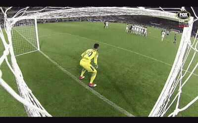 A Soccer Goalie Stands On The Edge Of The Goal Watching A Soccer Game Being Played . GIF