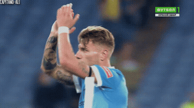A Soccer Player Applauds In Front Of A Tv Screen That Says Futbol 1 GIF
