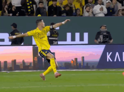 A Soccer Player Celebrates A Goal In Front Of A Large Sign That Says Kai GIF