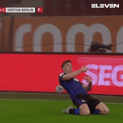 A Soccer Player Celebrates A Goal In Front Of A Screen That Says Hertha Berlin GIF