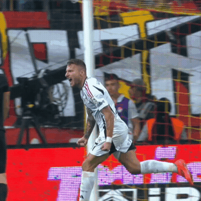 A Soccer Player Celebrates After Scoring A Goal In Front Of A Sign That Says ' Tb ' GIF