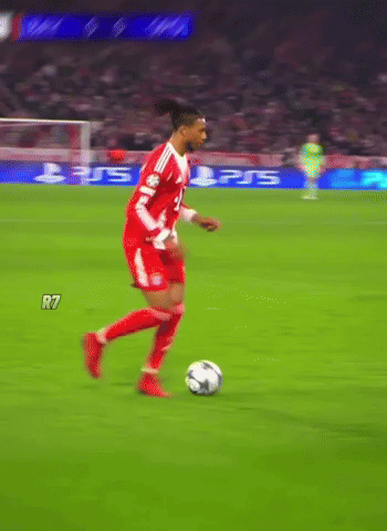 A Soccer Player Dribbles A Ball On A Field With A Ps5 Ad Behind Him GIF